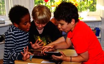 Admissions Lower School students looking at screen